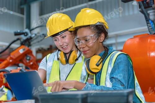 Preview: Women engineer worker working team helping together at work in modern advance machine factory.