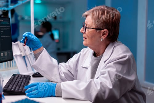 Preview: Scientist analysing blood test sample in medical facility