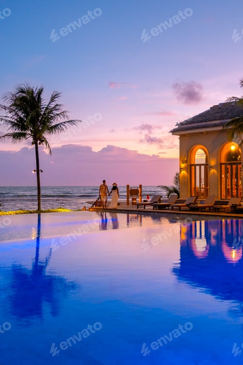 Preview: a young couple of men and women at a swimming pool during a vacation on a tropical island