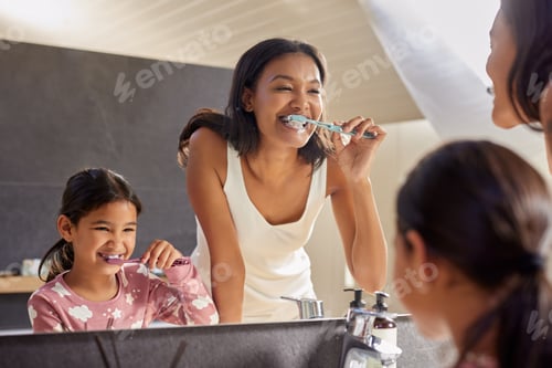 Preview: Indian mother and little daughter brushing teeth in the morning