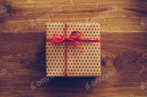 Preview: Red Polka Dot Gift on Wood Table