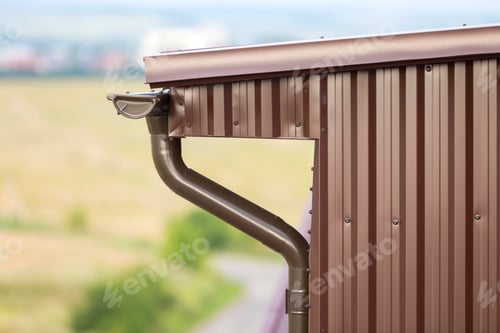 Preview: Close-up detail of cottage house corner with metal planks siding and roof with gutter rain system.