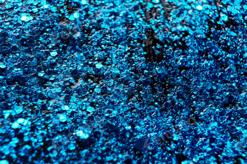 Preview: Blue glitter makeup product background. Eye shadow, lip gloss and face for holiday makeup backdrop
