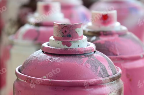 Preview: A lot of dirty and used aerosol cans of bright pink paint