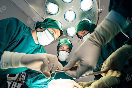 Preview: Surgeons Working Under Bright Lights in Operating Room