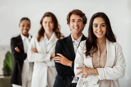 Preview: Multiracial business team standing in line with folded arms smiling at camera, selective focus on