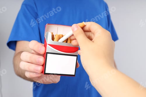 Preview: Female hand take cigarette from pack in man's hand