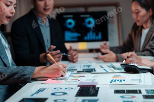 Preview: Business team analyzing financial charts and graphs, developing strategy