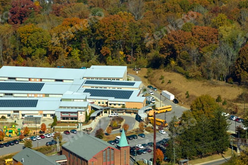 Preview: View from above of american school campus with roof covered with photovoltaic solar panels