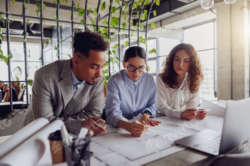 Preview: Collaborative Workspace Featuring a Team Engaging in Comprehensive Analysis of Plans