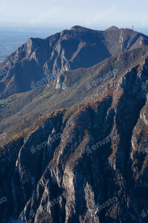 Preview: Beautiful landscape of the layered misty hazy Italian Alps mountain range during evening. Lombardy