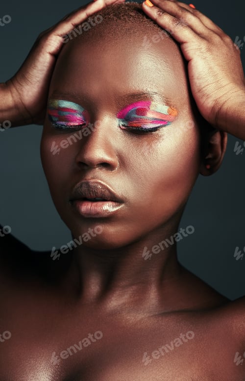 Preview: Cropped shot of a beautiful woman wearing colorful eyeshadow while posing against a grey background