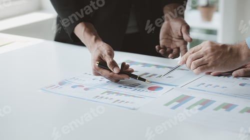 Preview: Two businessmen are brainstorming together and reviewing the company financial documents that the fi