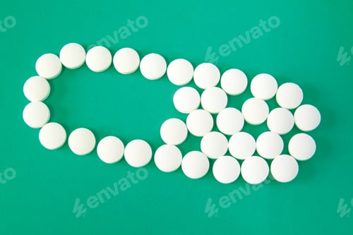 Preview: Medicine pills in capsule shape on green background