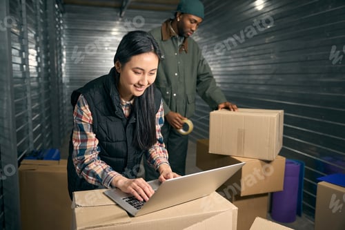 Preview: Team of storehouse employees preparing goods for shipment