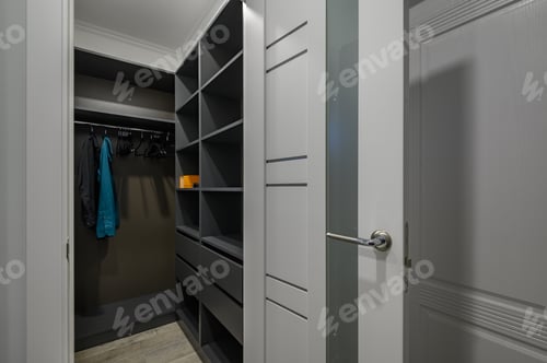 Preview: Contemporary Wardrobe with Clothes on Hangers and Shelves