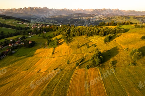 Preview: Sunrise over rolling hills and agriculture landscape
