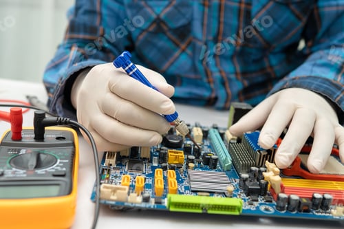 Preview: technician repairing inside of hard disk by soldering iron. Integrated Circuit.