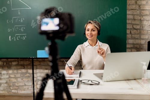 Preview: Elementary school teacher giving online class from the classroom.