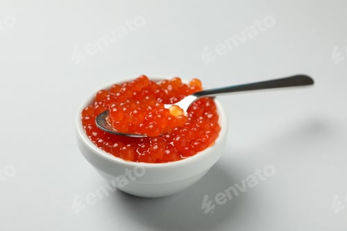 Preview: Bowl and spoon with caviar on gray background
