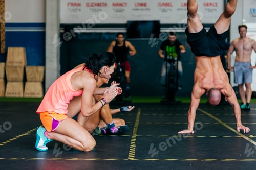 Preview: Women watching sportsman doing handstand