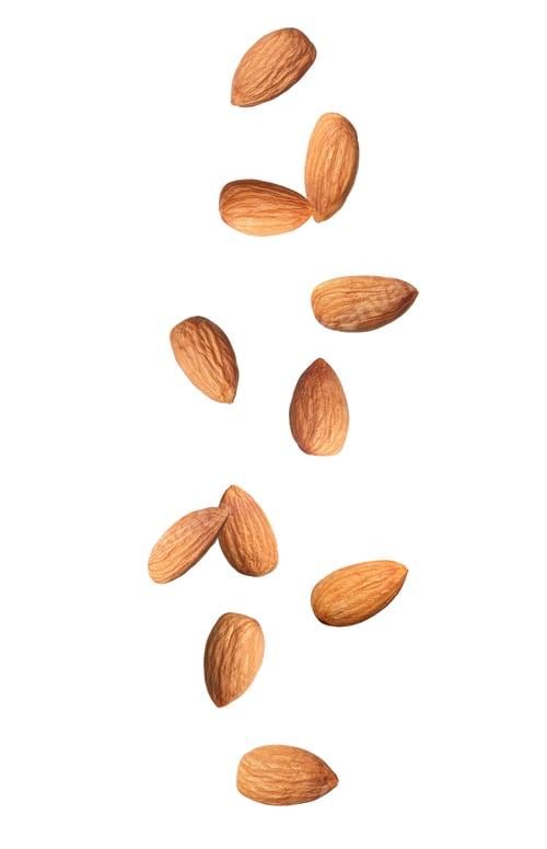 Preview: Many tasty almonds falling on white background