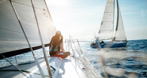 Preview: Young handsome man relaxing on his sailboat