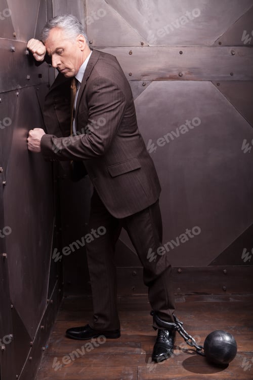 Preview: Chained businessman.