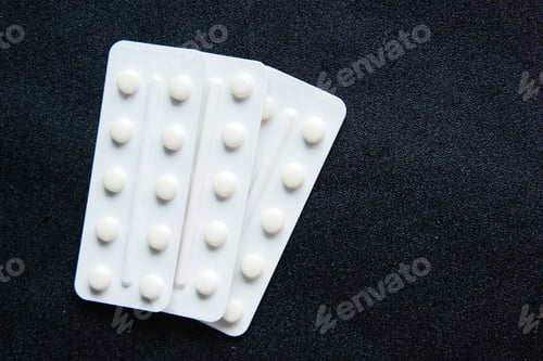 Preview: Close up of pills of blister pack on black background