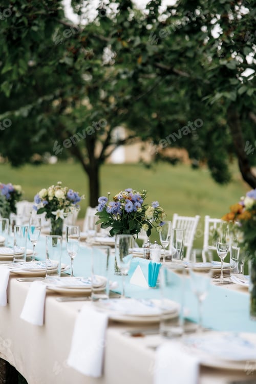 Preview: Photo of festive table in summer outdoor. Cozy vibe.