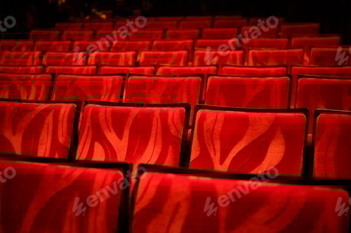 Preview: Closeup of empty red colored seats in a movie theatre with no person