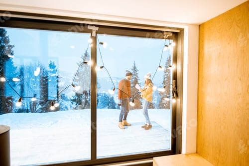 Preview: House with fireplace and couple on the terrace during the winter
