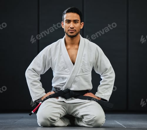 Preview: Male coach ready for karate training at fitness studio, looking serious at dojo practice in gym and