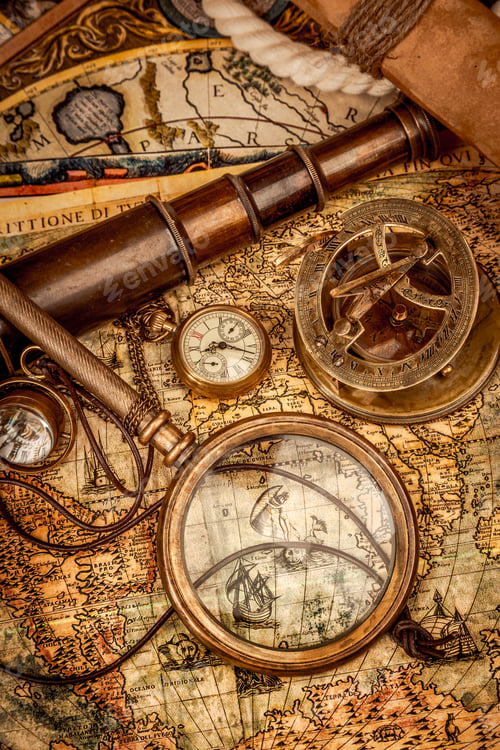 Preview: Vintage style travel and adventure. Vintage old compass and other vintage items on the table.