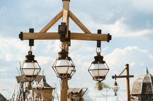 Preview: Old wooden lanterns hanging on a wooden pole