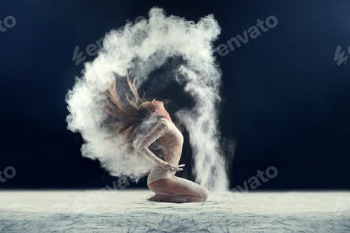 Preview: Studio shot of a young woman leaving a trail of powder in the air by whipping her hair