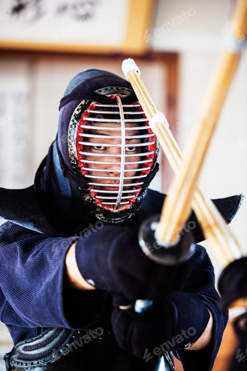 Preview: Close up of Japanese Kendo fighter wearing Kendo mask in combat pose.