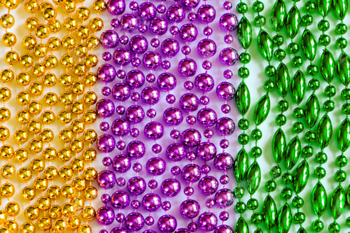 Preview: Mardi Gras background. Multi-colored beads close-up.
