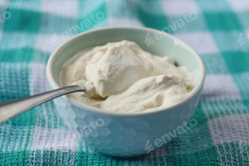 Preview: milk cream in a container on table cloth