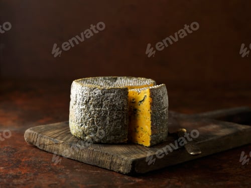 Preview: Truckle of blacksticks blue cheese on chopping board