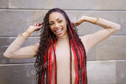 Preview: A Stylish Young Woman with Long, Beautifully Braided Hair in a Vibrant Urban Setting