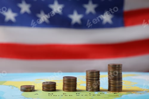 Preview: Stacks of USA cents on map against blurred flag