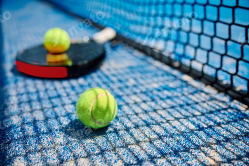 Preview: Paddle tennis ball and racket on the court.
