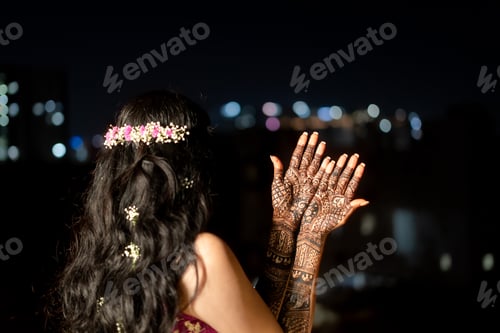 Preview: Woman raises her hands in the night