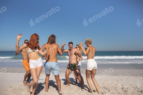 Preview: Overview of group of young diverse friends dancing together on the beach