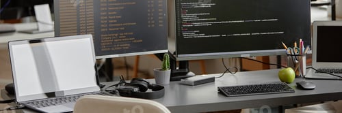 Preview: Computers with Lines of Code Running on Screens in Software Engineer Workspace