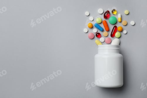 Preview: Pills and Capsules Spill from a White Bottle