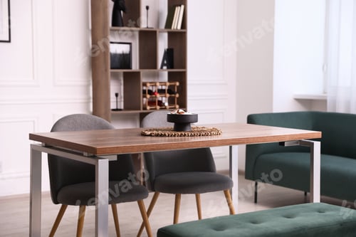 Preview: Wooden table with chairs, bench and decor in dining room. Interior design