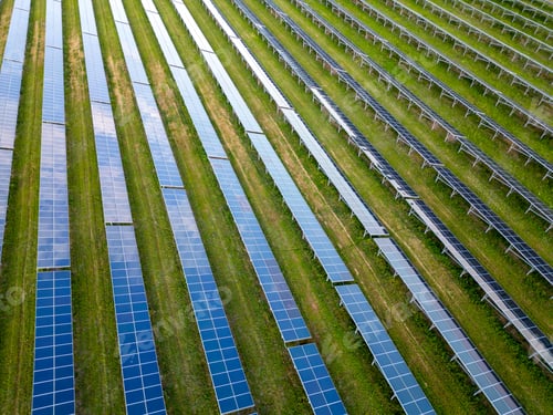 Preview: big solar power station on a green meadow aerial view