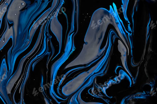 Preview: Close-up shot of thick paint of various bright colors flowing down and mixing together